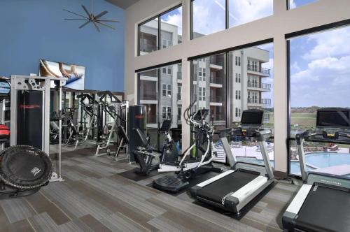 a gym with treadmills and cardio equipment in a building at The Stockyard Retreat - Pool, Gym & Free Parking in Fort Worth
