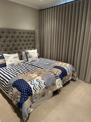 a bedroom with two beds with pillows on them at Sea Breeze in Mossel Bay