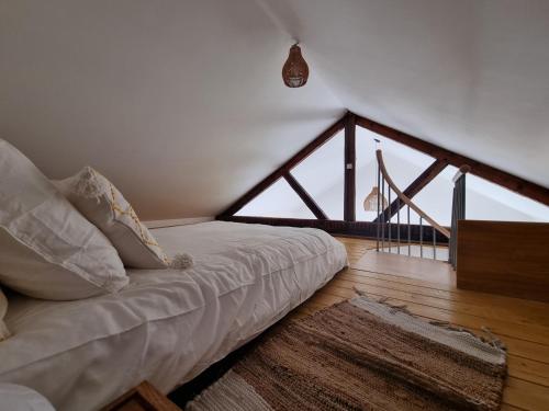 a white couch in a room with a large window at Gite du Bois de Lord in Grandham