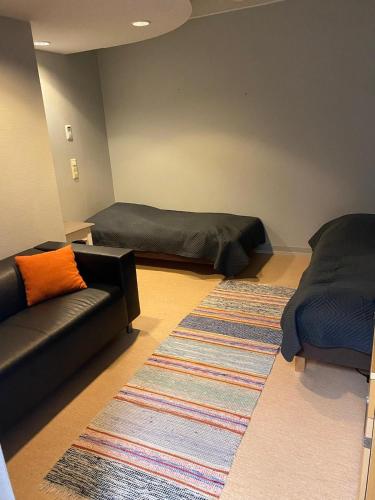 a living room with two beds and a couch at Varastotie 1C in Ylivieska