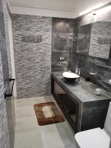 a bathroom with a sink and a shower at VILLA Keur Diam in Somone