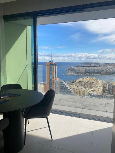 a view of the city from a window in a building at Mercury tower Elena K 24th Floor panoramic view Apt in St. Julianʼs
