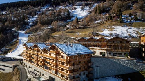 an aerial view of a building with snow on the ground at Dent Blanche Resort - TemptingPlaces Collection in Hérémence