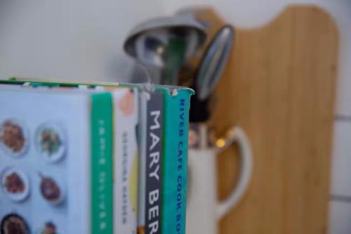 a cup with a pair of scissors on top of it at Clifton Village Apartment in Bristol
