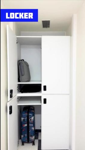 a room with a white closet with a door open at Nap Junction in Pune