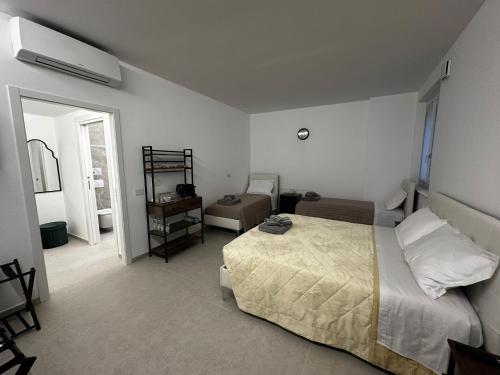 a bedroom with a bed and a chair in it at GV Guest House Malpensa in Lonate Pozzolo
