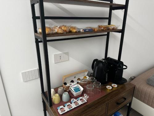 a shelf with pastries and other items on it at GV Guest House Malpensa in Lonate Pozzolo