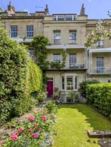 a large house with a garden in front of it at Clifton Village Apartment in Bristol