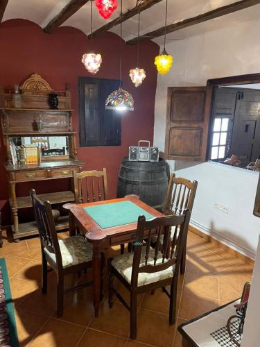 a dining room with a table and chairs and a wine barrel at CASA RURAL VICENTA 1750 Alojamiento rural, capacidad hasta 30 personas in Albentosa