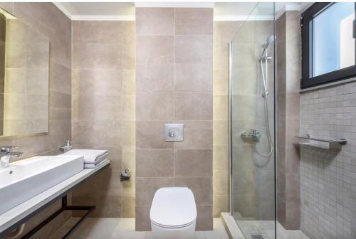 a bathroom with a toilet and a sink and a shower at Villa Lambis Athena in Lindos