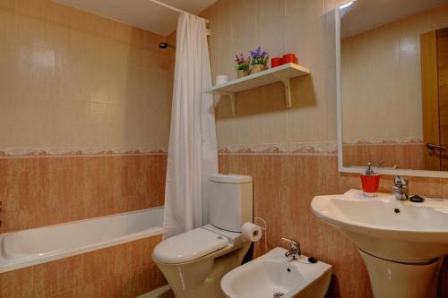 a bathroom with a white toilet and a sink at Belair Tazacorte in Tazacorte