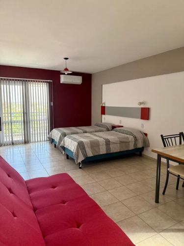 a living room with two beds and a couch at Vanguardia Suites in San Juan