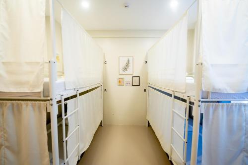 a hallway of a hospital room with white cabinets at Cozypod Rentals in Sagcahan