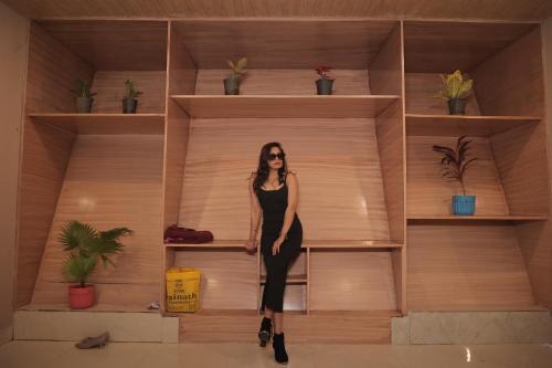 a woman in a black dress standing on a shelf at The triangle haven escape in Ani