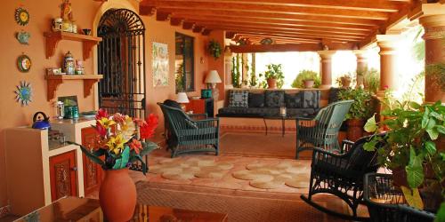 a living room with a couch and a table and chairs at La Valise Los Cabos in Boca de la Vinorama
