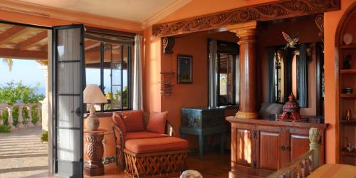 a living room with a chair and a table at La Valise Los Cabos in Boca de la Vinorama