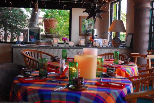a table in a restaurant with a colorful table cloth at La Valise Los Cabos in Boca de la Vinorama