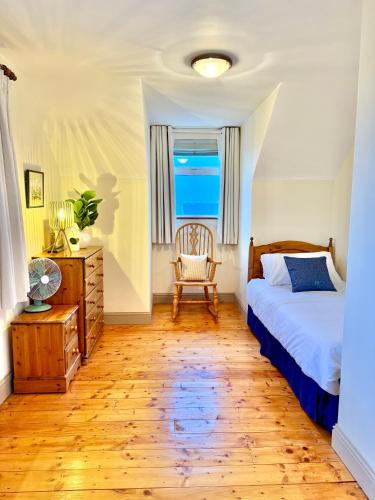 a bedroom with a bed and a chair and a window at The Willows in Kerry in Tralee