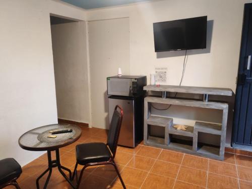 a living room with a table and a fireplace at Depa Banthi in San Juan del Río