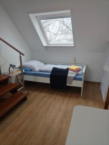 a small bedroom with a bed and a window at Apartment 10 in Surwold