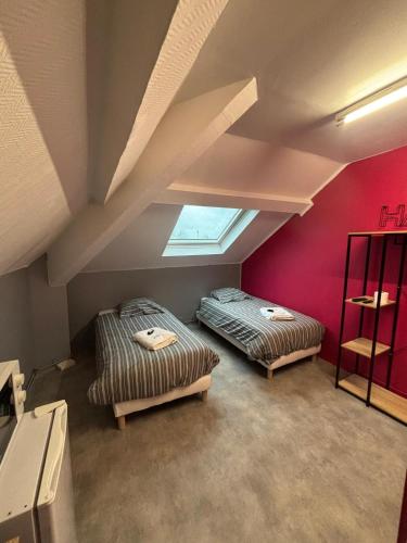 two beds in a attic room with a window at Capstay - Trith Netflix in Trith-Saint-Léger