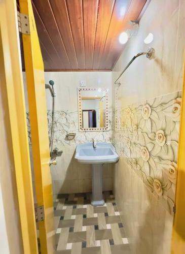 a bathroom with a sink and a mirror at Daya Guest House in Pattipola