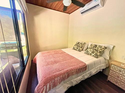 a small bedroom with a bed and a window at M&M Container Home in Sardinal
