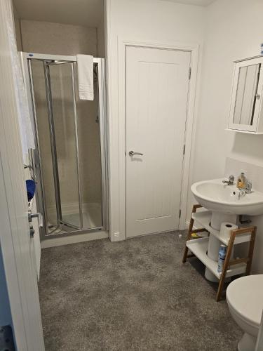 a bathroom with a shower and a sink at Inverloch self catering in Orkney