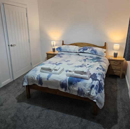 a bedroom with a bed with towels on it at Inverloch self catering in Orkney
