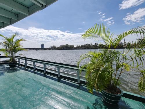 a swimming pool next to a body of water at AHHA Floatel Kampot in Kampot