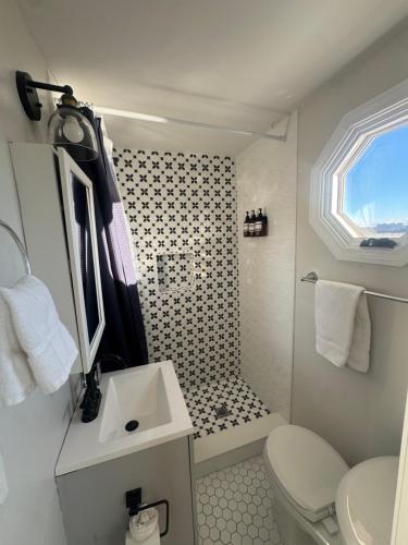 a bathroom with a toilet and a sink and a shower at Waterfront Escape HotTub, Pets OK, Pool Table in Dennis