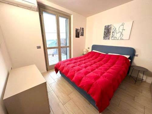 a large red bed in a room with a window at Iseo Panorama Suite in Parzanica