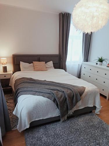 a bedroom with a large bed with a rug at Relax Inn Otepää Apartment in Otepää