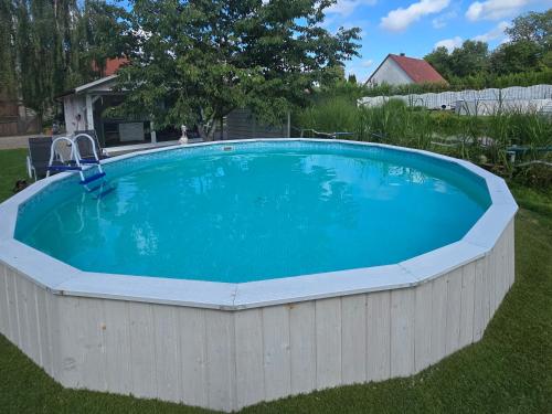 a large swimming pool in a yard with a fence at Agroturystyka Nad-Stawem 2 in Wielowieś