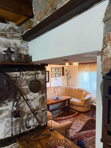 a living room with a couch and a table at Lithos Home in Panagia