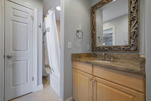 a bathroom with a sink and a mirror at Twin Palms - Beachfront Duplex with Ocean Views & Direct Beach Access in Destin