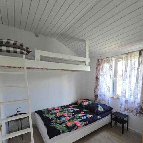 a bedroom with a bunk bed and a ladder at Agroturystyka Nad-Stawem 2 in Wielowieś