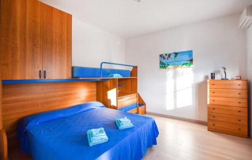 a bedroom with a blue bed and a dresser at Casa Vincenzo in Satriano