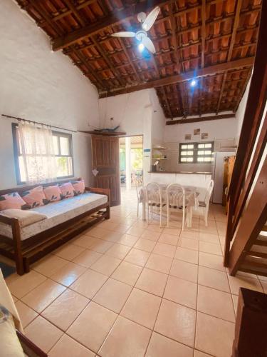 a bedroom with a bed and a table and chairs at Íkaia Surf House in Ubatuba