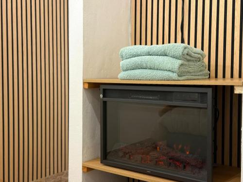 a fireplace with a towel on top of it at Casa Carlinhos da Carreira in Terras de Bouro