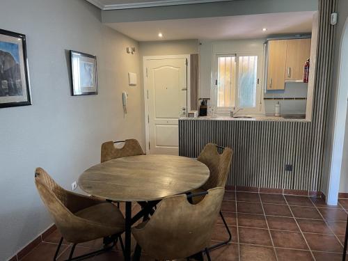 a kitchen with a table and chairs in a room at Parque Vera 5 in Vera