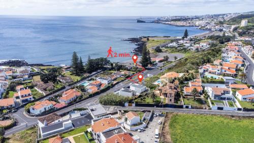 an aerial view of a city with the ocean at Beach Front Villa in Ponta Delgada