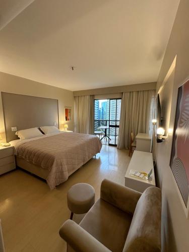 a hotel room with a bed and a couch at Kubitschek Plaza Hotel - Flat Particular ALM in Brasília