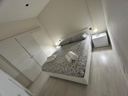 a bedroom with a bed with two pillows on it at CARPI SUITE - Appartamenti Minghetti in Carpi