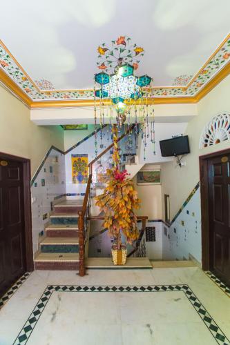 a room with a staircase with a chandelier at Hotel Moon Light Palace in Jaipur