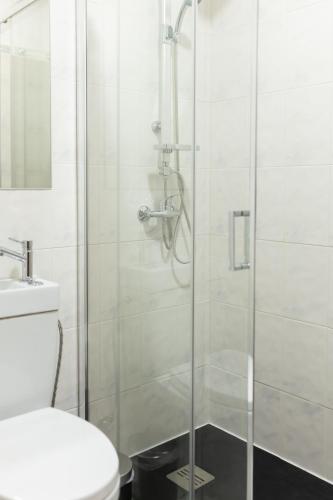 a shower with a glass door in a bathroom at Ermal Green Haven in Vieira do Minho