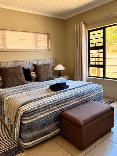 a bedroom with a large bed and a window at 10 on Sysie in Sedgefield