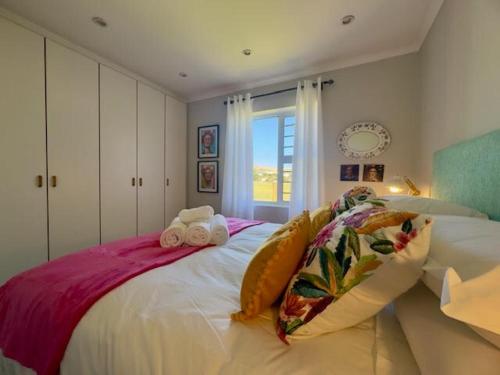 a bedroom with a bed with two towels on it at Sunset View in Durbanville