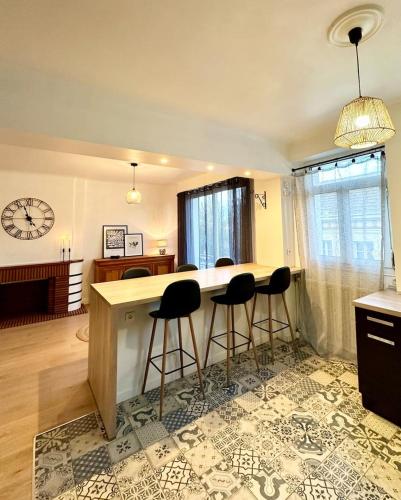 a kitchen with a counter and bar stools at L'Évasion - Centre-Ville & Garage Privé in Mont-de-Marsan