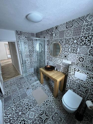 a bathroom with a toilet and a sink and a mirror at Vila Dom pod Chopkom in Bystrá
